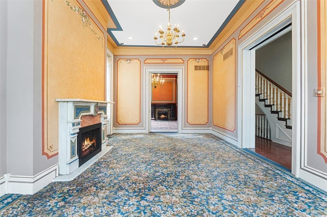 3534 Washington Ave, Saint Louis, MO 63103 - corridor featuring a chandelier, carpet floors, stairway, crown molding, and a decorative wall