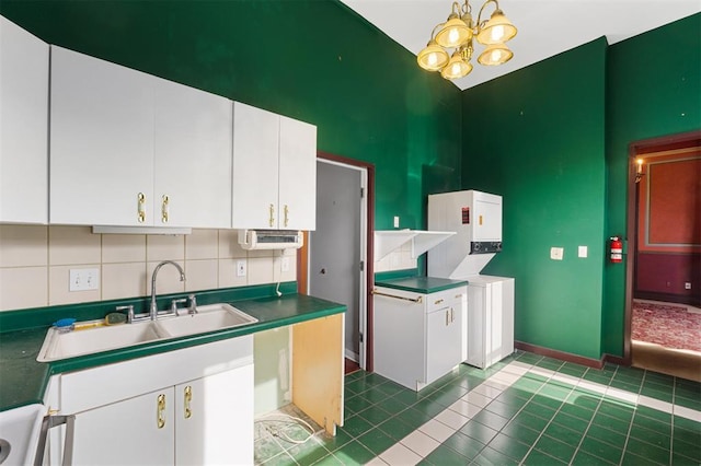 3534 Washington Ave, Saint Louis, MO 63103 - kitchen featuring a high ceiling, a sink, white cabinets, a chandelier, and tile patterned flooring