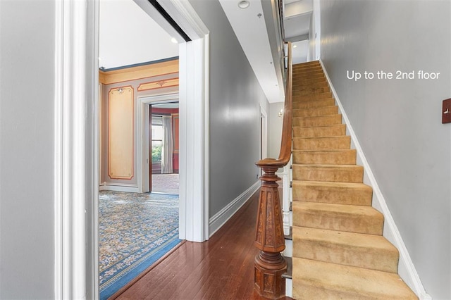 3534 Washington Ave, Saint Louis, MO 63103 - staircase featuring baseboards and wood finished floors