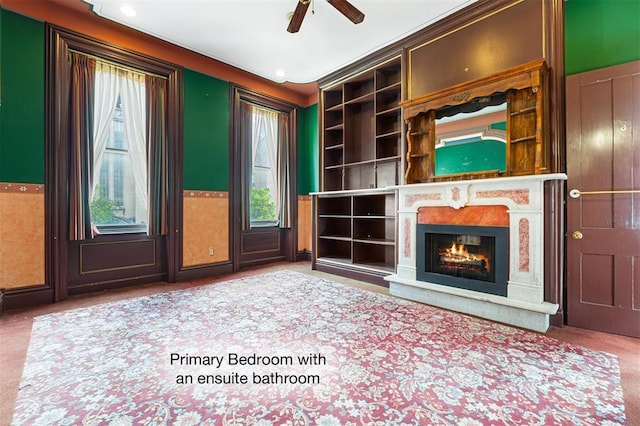 3534 Washington Ave, Saint Louis, MO 63103 - unfurnished living room featuring carpet floors, ceiling fan, and a lit fireplace