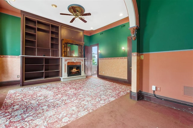 3534 Washington Ave, Saint Louis, MO 63103 - unfurnished living room featuring ceiling fan, carpet floors, a warm lit fireplace, and recessed lighting