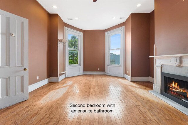 3534 Washington Ave, Saint Louis, MO 63103 - unfurnished living room with wood-type flooring, a premium fireplace, baseboards, and recessed lighting