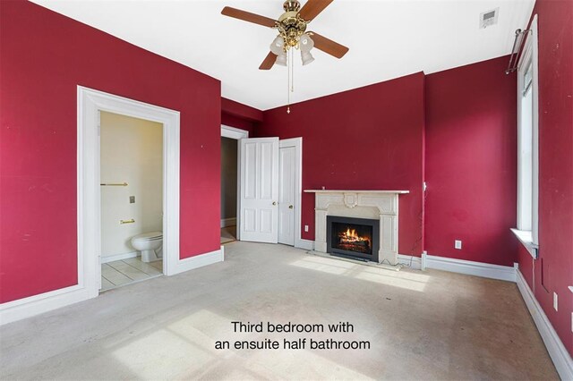 3534 Washington Ave, Saint Louis, MO 63103 - unfurnished living room featuring ceiling fan, a premium fireplace, carpet floors, and baseboards