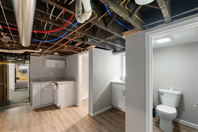 3534 Washington Ave, Saint Louis, MO 63103 - basement featuring light wood-type flooring and baseboards