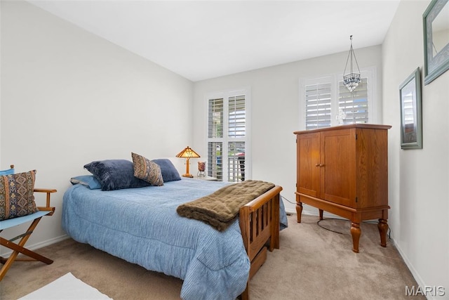 13116 Ambrose Ct, Black Jack, MO 63033 - bedroom featuring light carpet, baseboards, and a chandelier