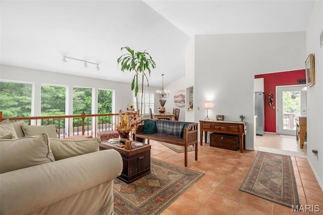13116 Ambrose Ct, Black Jack, MO 63033 - living area featuring healthy amount of natural light, high vaulted ceiling, and a chandelier