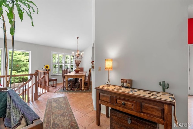 13116 Ambrose Ct, Black Jack, MO 63033 - hall with a chandelier, lofted ceiling, light tile patterned floors, and baseboards
