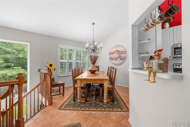 13116 Ambrose Ct, Black Jack, MO 63033 - dining area with a chandelier, light tile patterned floors, baseboards, and lofted ceiling