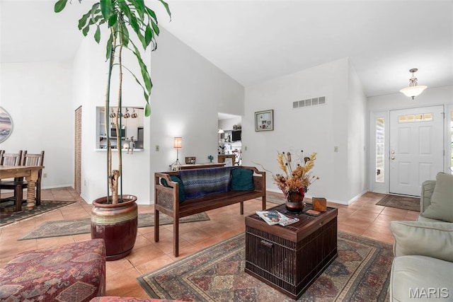 13116 Ambrose Ct, Black Jack, MO 63033 - living room with high vaulted ceiling, tile patterned flooring, and baseboards