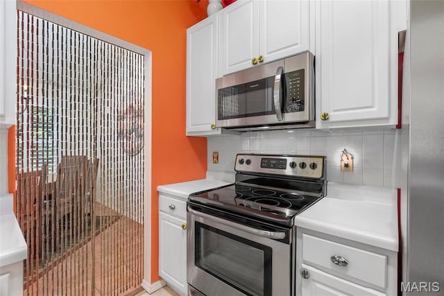 13116 Ambrose Ct, Black Jack, MO 63033 - kitchen featuring appliances with stainless steel finishes, decorative backsplash, light countertops, and white cabinetry