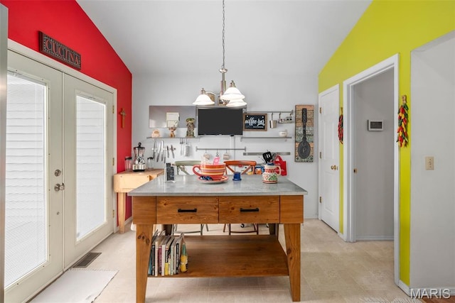 13116 Ambrose Ct, Black Jack, MO 63033 - kitchen with french doors, vaulted ceiling, a chandelier, and hanging light fixtures