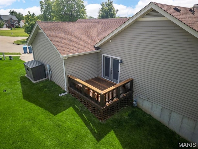 13116 Ambrose Ct, Black Jack, MO 63033 - back of property with french doors, a wooden deck, a lawn, and roof with shingles