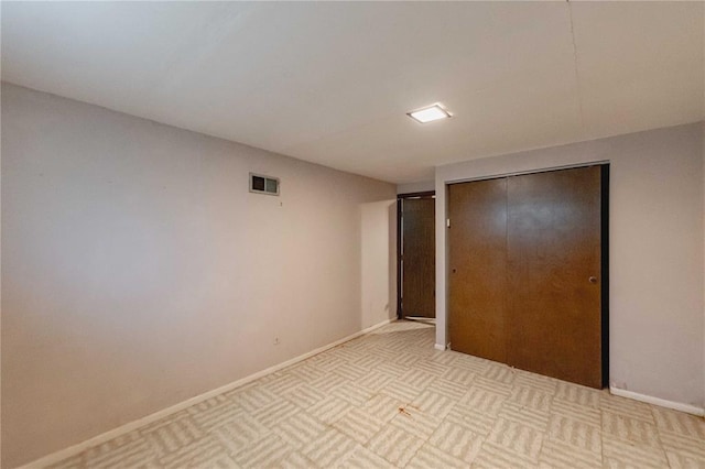 unfurnished bedroom with a closet and baseboards
