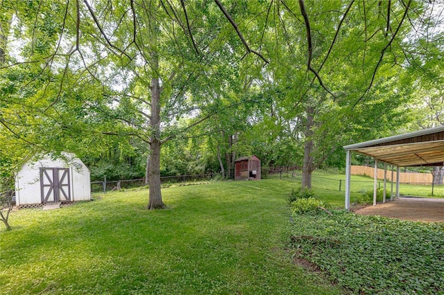 view of yard with an outdoor structure, a storage shed, and a barn