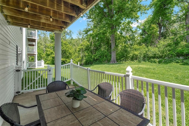 1408 Summertree Springs Ave Unit C, Valley Park, MO 63088 - wooden terrace with outdoor dining space, a lawn, and view of scattered trees