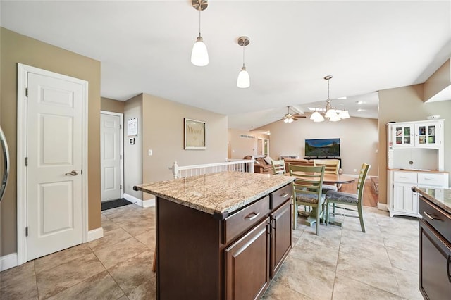 14 Heavenly Valley Dr, Dardenne Prairie, MO 63368 - kitchen featuring dark brown cabinetry, hanging light fixtures, baseboards, a kitchen island, and vaulted ceiling