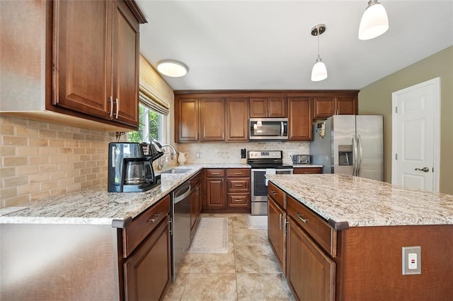 14 Heavenly Valley Dr, Dardenne Prairie, MO 63368 - kitchen with stainless steel appliances, a kitchen island, backsplash, and light stone counters