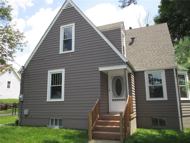 rear view of property featuring a shingled roof