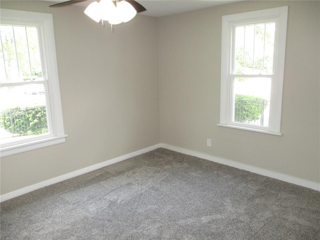 empty room featuring carpet flooring, ceiling fan, and baseboards