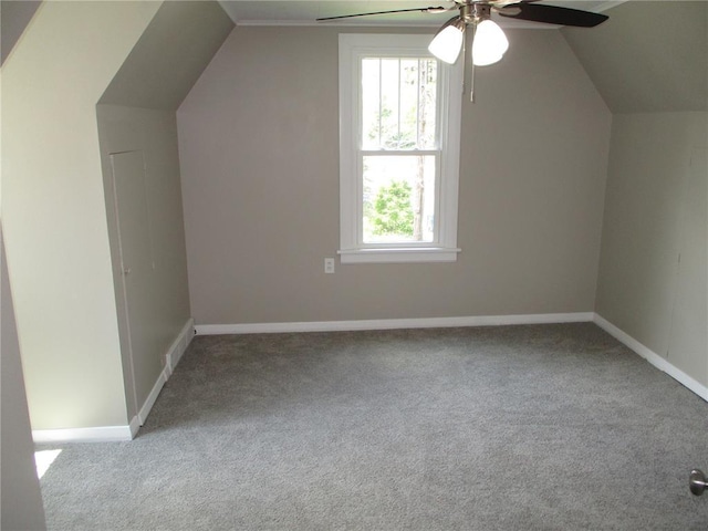 bonus room with carpet flooring, vaulted ceiling, ceiling fan, and baseboards