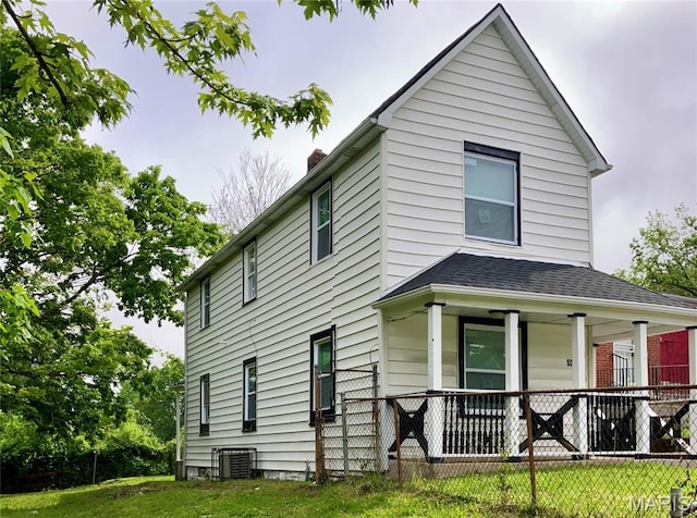 5379 Wabada Ave, Saint Louis, MO 63112 - view of front facade with covered porch, a chimney, and a shingled roof