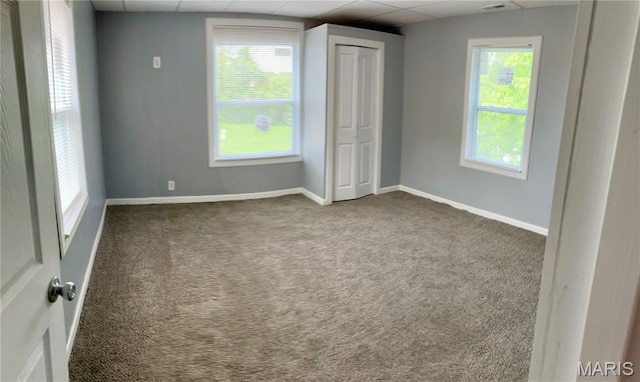 5379 Wabada Ave, Saint Louis, MO 63112 - unfurnished bedroom featuring a drop ceiling, carpet floors, and a closet