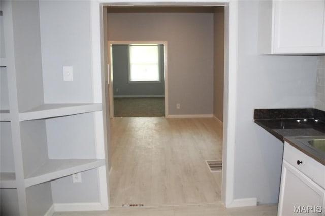 5379 Wabada Ave, Saint Louis, MO 63112 - kitchen with white cabinetry and light wood-style flooring