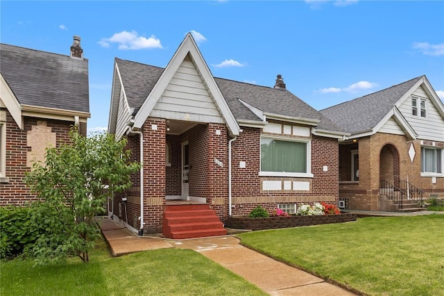6266 Marmaduke Ave, Saint Louis, MO 63139 - tudor-style house with brick siding, a front yard, and roof with shingles