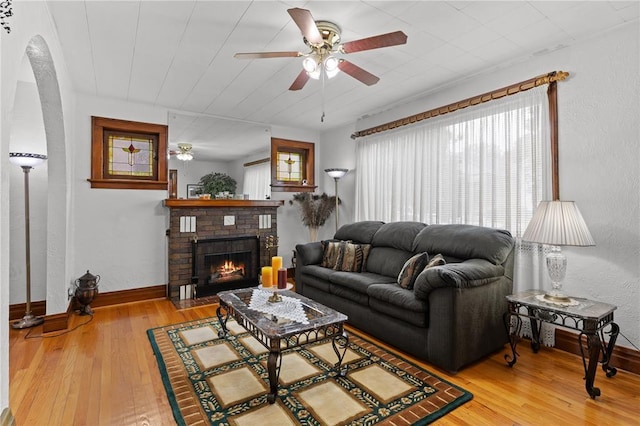 6266 Marmaduke Ave, Saint Louis, MO 63139 - living area featuring a ceiling fan, hardwood / wood-style flooring, a brick fireplace, and baseboards