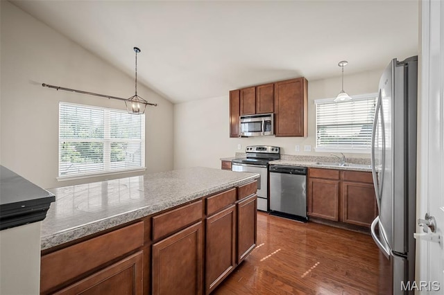 533 Bramblett Hls, Ofallon, MO 63366 - kitchen with stainless steel appliances, brown cabinets, lofted ceiling, pendant lighting, and dark wood-style floors