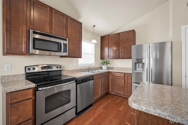 533 Bramblett Hls, Ofallon, MO 63366 - kitchen with stainless steel appliances, vaulted ceiling, a sink, dark wood-type flooring, and light countertops
