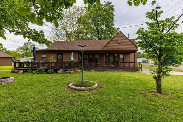 506 N Garfield, East Prairie, MO 63845 - rear view of house featuring a lawn, covered porch, and roof with shingles