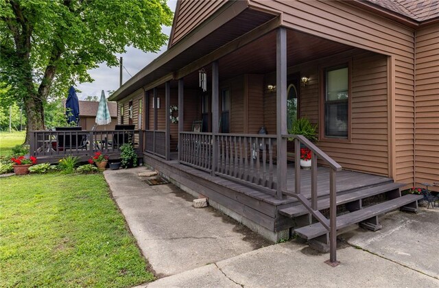 506 N Garfield, East Prairie, MO 63845 - property entrance featuring a lawn and covered porch