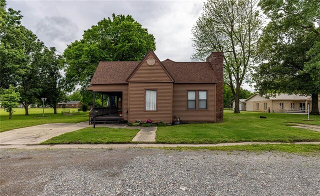 506 N Garfield, East Prairie, MO 63845 - view of front of property featuring a front yard, a chimney, and roof with shingles