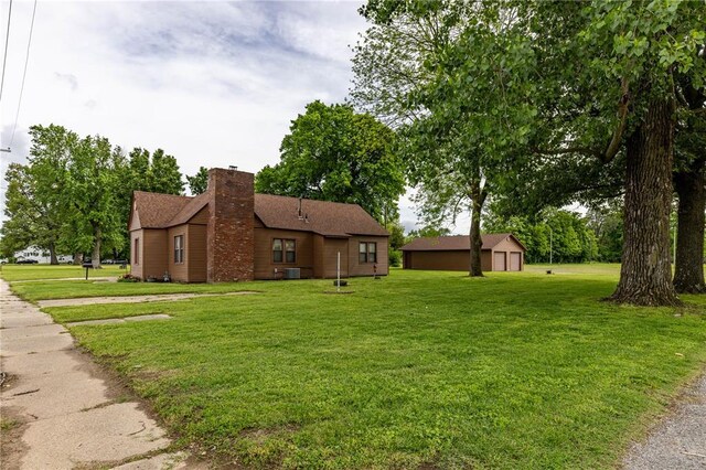 506 N Garfield, East Prairie, MO 63845 - view of property exterior with a yard and a chimney