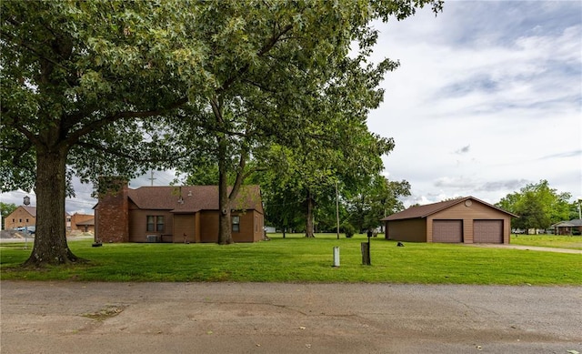 506 N Garfield, East Prairie, MO 63845 - view of property exterior with a garage, a yard, a chimney, and an outbuilding