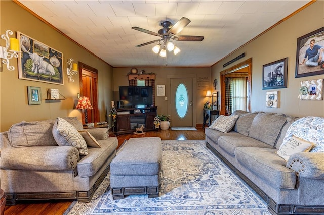 506 N Garfield, East Prairie, MO 63845 - living room featuring wood finished floors, a ceiling fan, and ornamental molding
