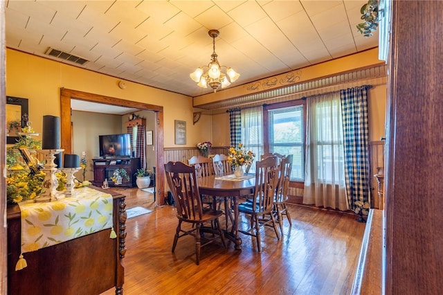 506 N Garfield, East Prairie, MO 63845 - dining room featuring a chandelier, wood finished floors, and wainscoting