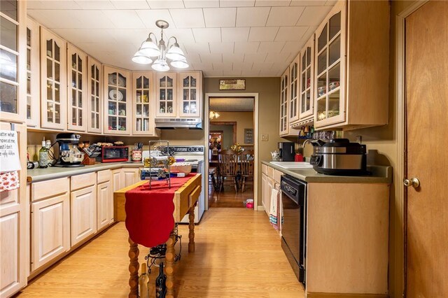 506 N Garfield, East Prairie, MO 63845 - kitchen featuring black dishwasher, under cabinet range hood, stove, a sink, and a chandelier
