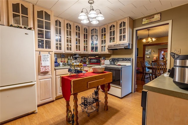 506 N Garfield, East Prairie, MO 63845 - kitchen featuring white appliances, a chandelier, under cabinet range hood, and light wood-style flooring