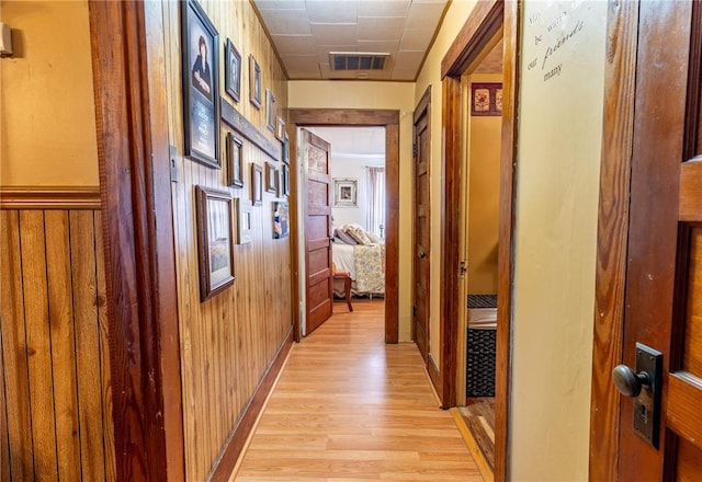 506 N Garfield, East Prairie, MO 63845 - hallway featuring light wood finished floors and wood walls