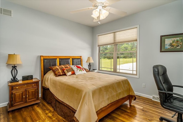 bedroom featuring dark wood-style floors, baseboards, and an office area