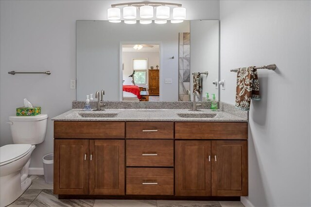 ensuite bathroom with toilet and double vanity