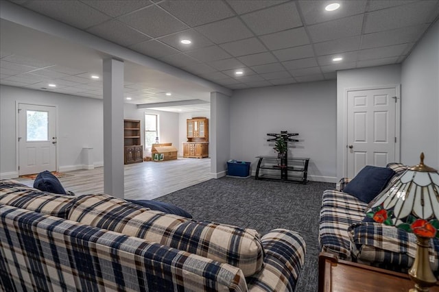 carpeted living area with baseboards and recessed lighting