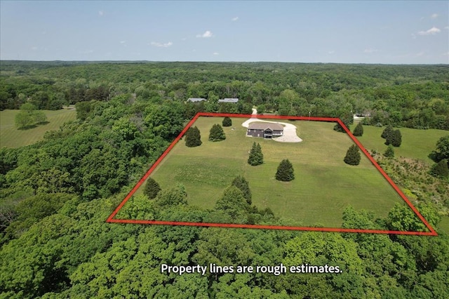 view from above of property featuring a forest and property boundaries highlighted