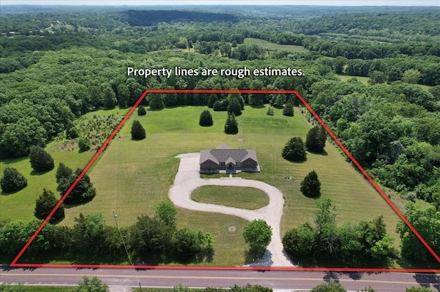 view of property location featuring property parcel outlined and a forest