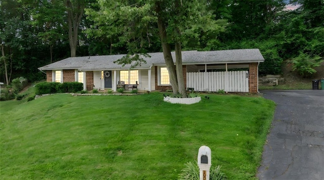 ranch-style house with brick siding and driveway
