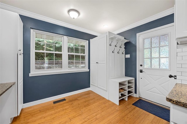 mudroom featuring light wood finished floors, plenty of natural light, crown molding, and baseboards
