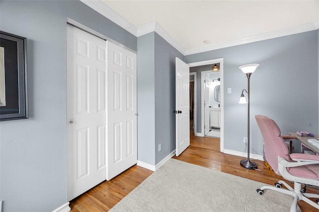 office featuring crown molding, wood finished floors, and baseboards