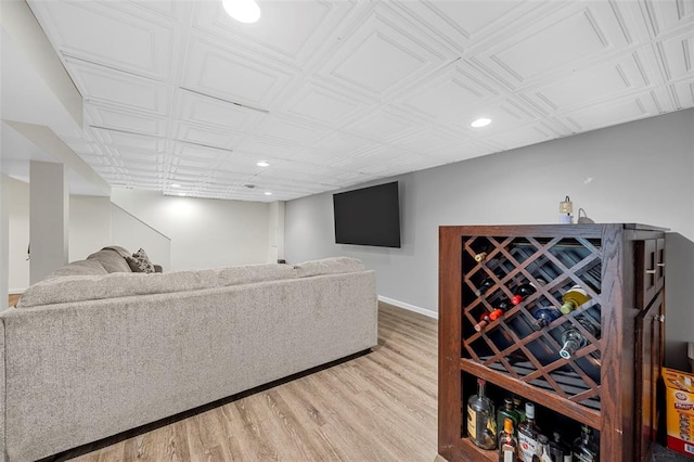 living room with recessed lighting, light wood finished floors, an ornate ceiling, and baseboards